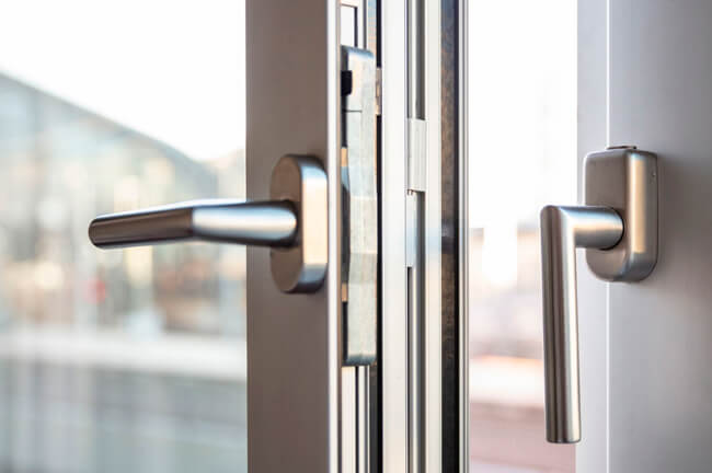 Engineer testing closer speed and clearances after glass door repair